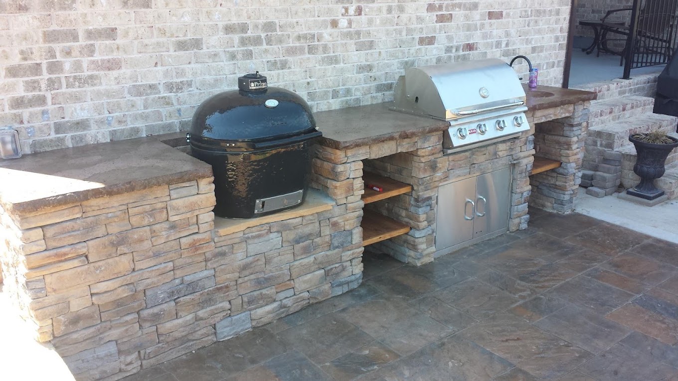 Stone outdoor kitchen with built-in grill and smoker beside the pool