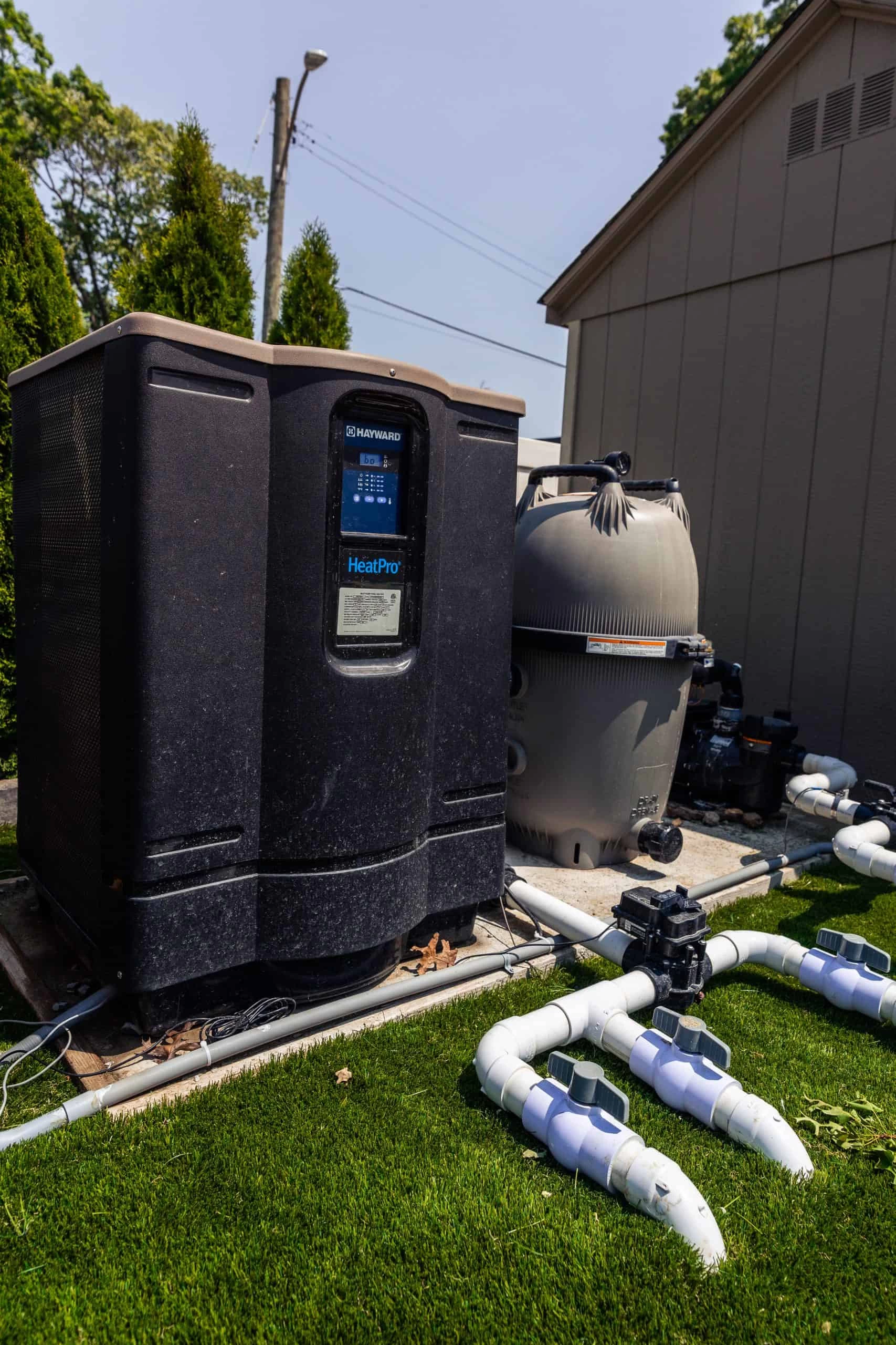 Pool heat pump and filtration equipment installed beside the house